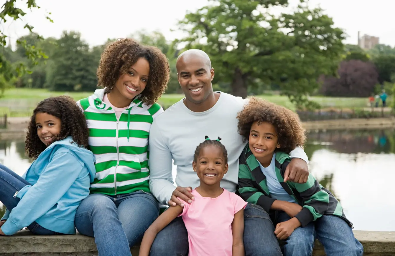 Happy family enjoying time outdoors together on a bench.