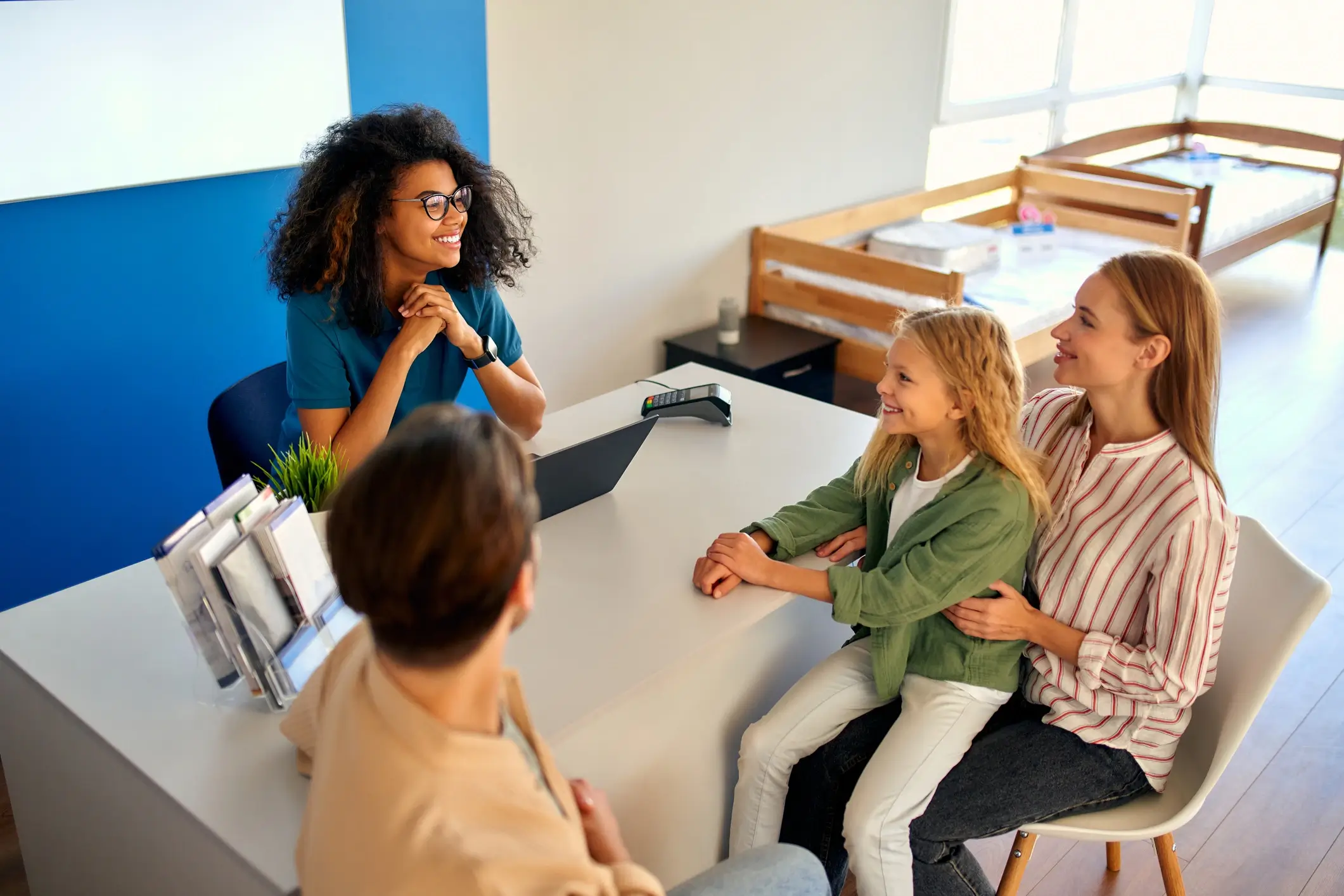 A diverse family discussing therapy with a counselor in a cozy office.