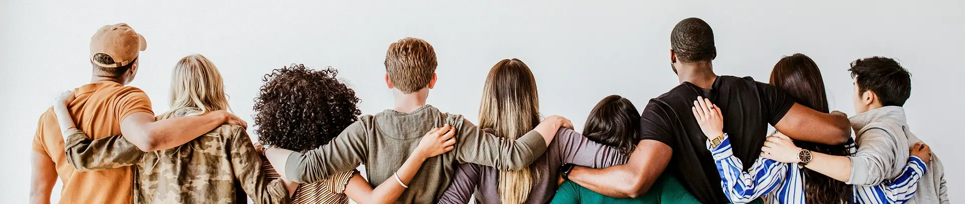 Children standing with arms around each other, showing friendship.